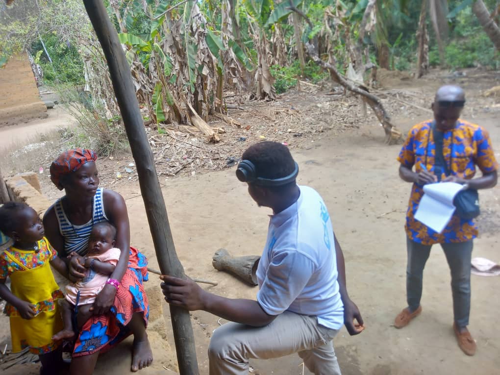 Man reading a book beside people